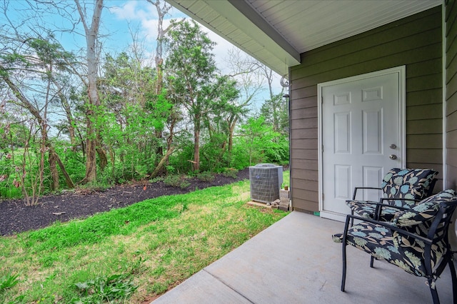view of yard featuring central air condition unit and a patio