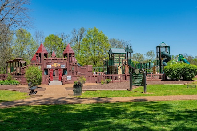 community jungle gym featuring a lawn