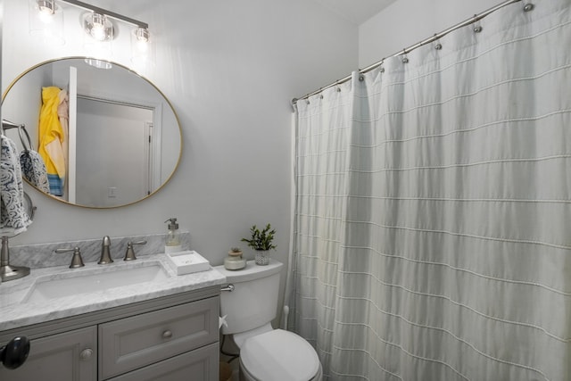 bathroom with toilet, vanity, and a shower with shower curtain