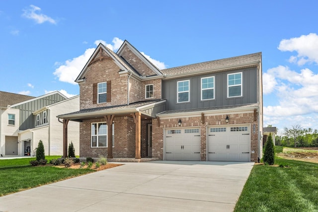 craftsman-style home with a garage, concrete driveway, board and batten siding, a front yard, and brick siding