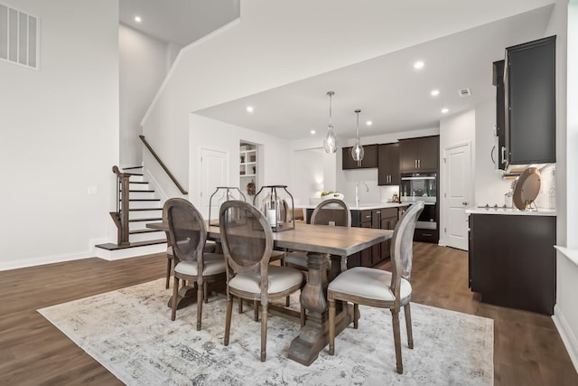 dining room featuring visible vents, recessed lighting, stairway, and dark wood finished floors