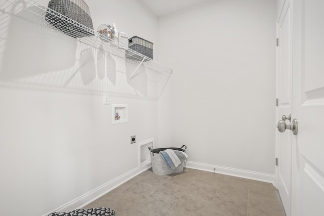 clothes washing area featuring baseboards, hookup for a washing machine, hookup for an electric dryer, and laundry area