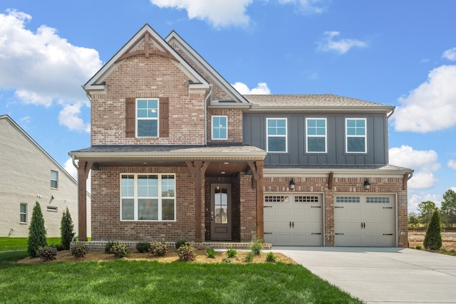 craftsman-style house with a front lawn, concrete driveway, brick siding, a garage, and board and batten siding