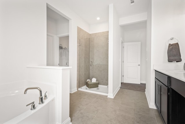 full bath with a spacious closet, tile patterned flooring, a bath, baseboards, and a stall shower