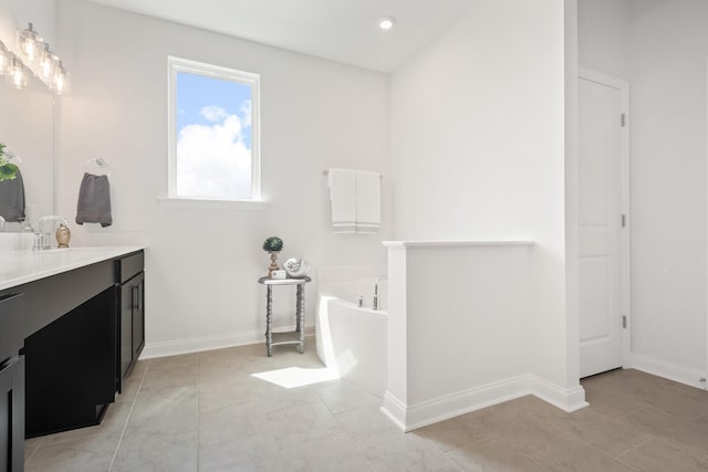 full bath with recessed lighting, tile patterned flooring, vanity, a bath, and baseboards