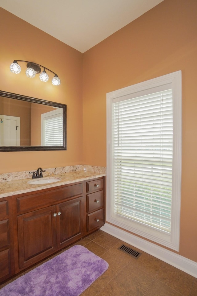 bathroom featuring visible vents, vanity, and baseboards