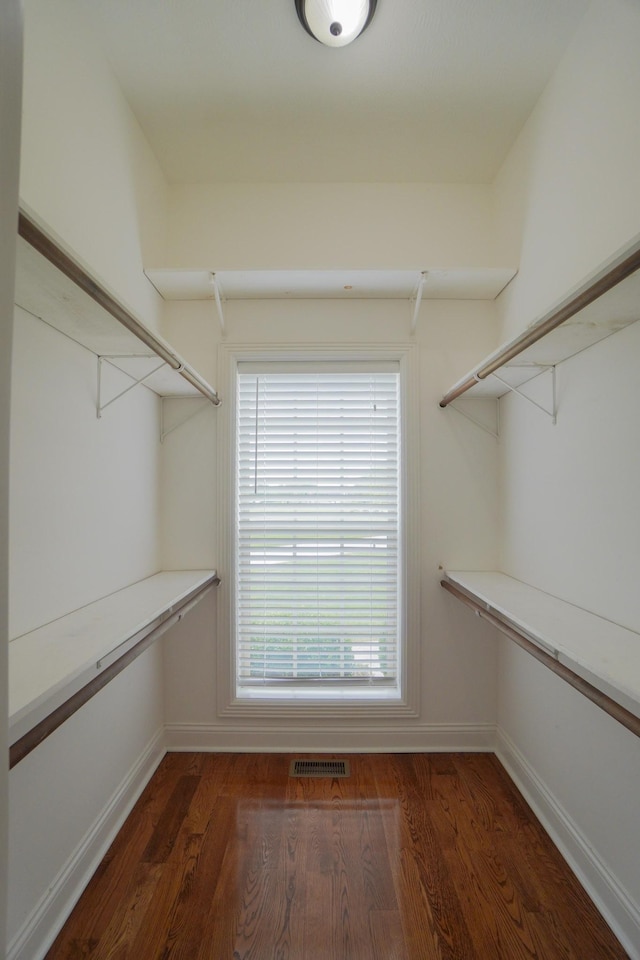 spacious closet featuring visible vents and wood finished floors