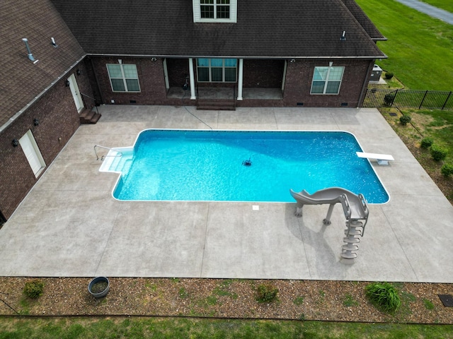 view of pool featuring a fenced in pool, a fenced backyard, a diving board, and a patio area