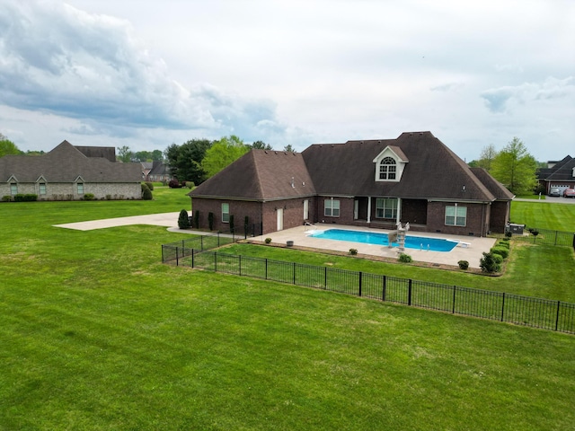 view of pool featuring a lawn, fence, a patio area, and a fenced in pool