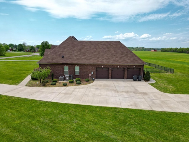 view of front of property with driveway, fence, a front lawn, and a garage