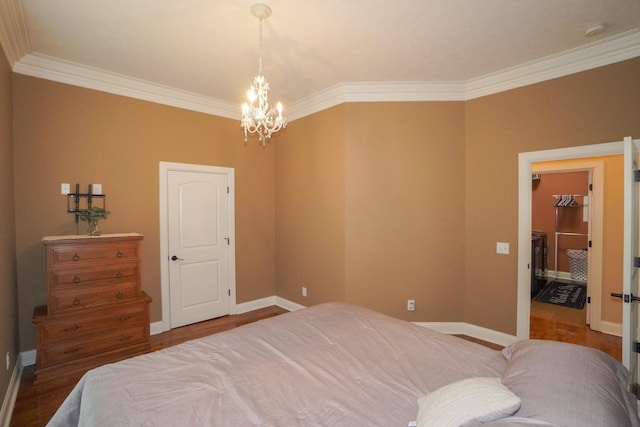 bedroom with wood finished floors, a chandelier, ornamental molding, and baseboards