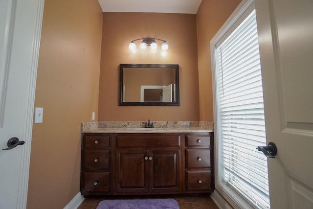 bathroom with tile patterned floors, vanity, and baseboards