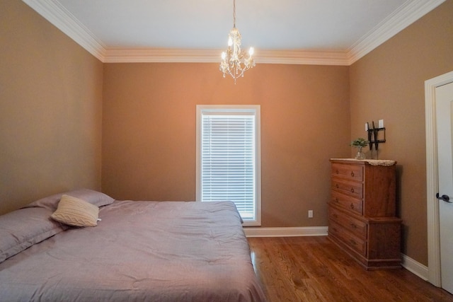 bedroom featuring wood finished floors, crown molding, a notable chandelier, and baseboards