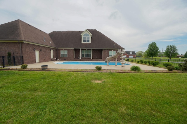 view of pool with a water slide, fence, a fenced in pool, and a patio area