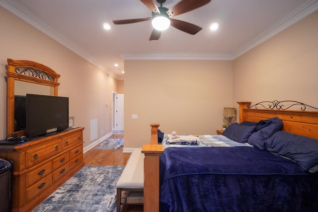 bedroom featuring visible vents, wood finished floors, crown molding, and recessed lighting