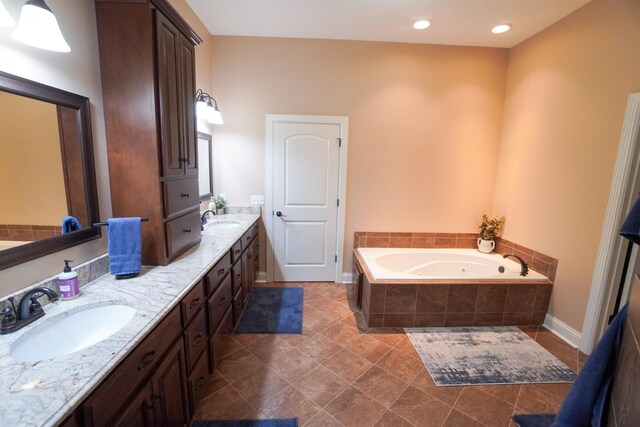 bathroom featuring double vanity, tile patterned floors, a bath, and a sink