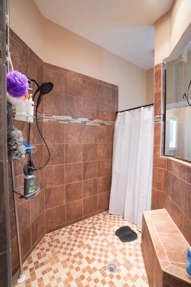 bathroom with tiled shower