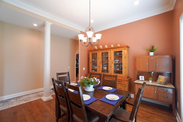 dining room with ornamental molding, an inviting chandelier, and dark wood-style flooring