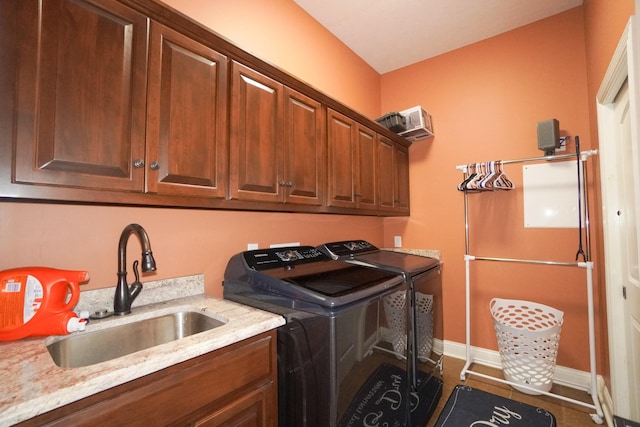 laundry area with separate washer and dryer, cabinet space, baseboards, and a sink