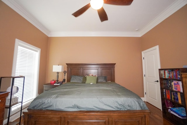 bedroom with wood finished floors, crown molding, and a ceiling fan