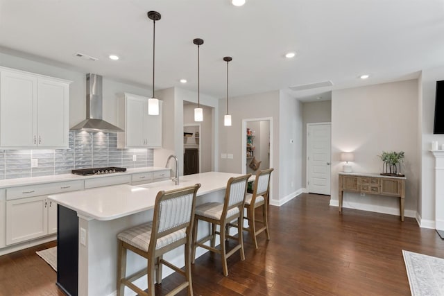 565 Kipton Trl, Lebanon, TN 37087 - kitchen with wall chimney exhaust hood, visible vents, gas cooktop, light countertops, and backsplash