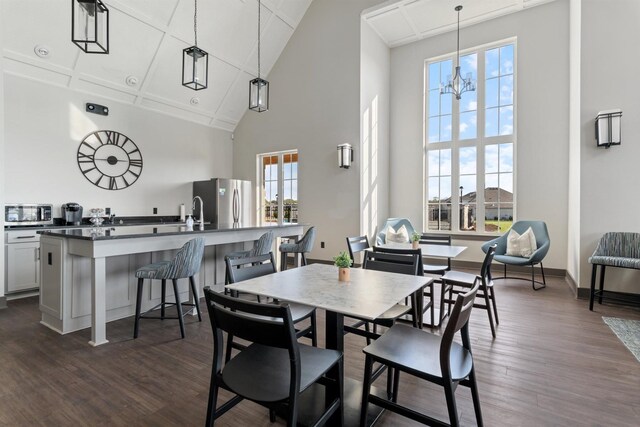565 Kipton Trl, Lebanon, TN 37087 - dining room featuring a notable chandelier, baseboards, high vaulted ceiling, and dark wood-type flooring