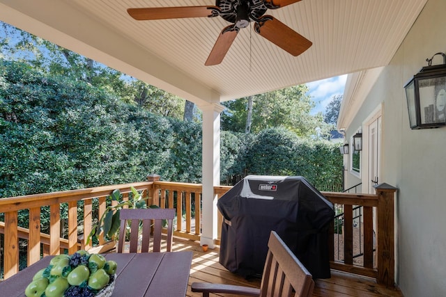 deck featuring grilling area and a ceiling fan