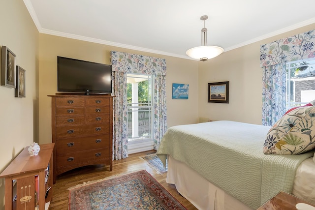 bedroom featuring crown molding and wood finished floors
