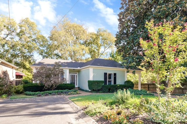 ranch-style house with fence and stucco siding