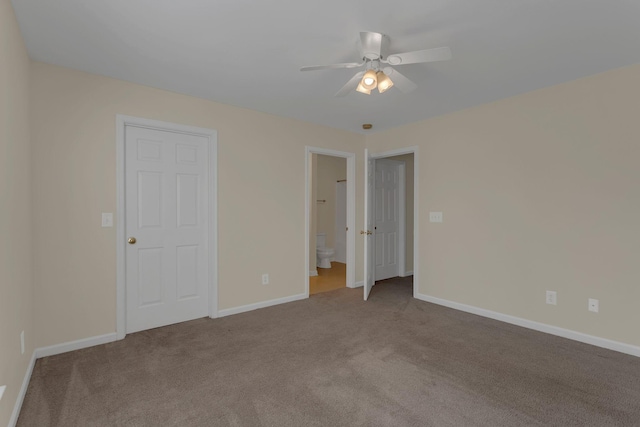 unfurnished bedroom with a ceiling fan, carpet flooring, baseboards, and ensuite bathroom