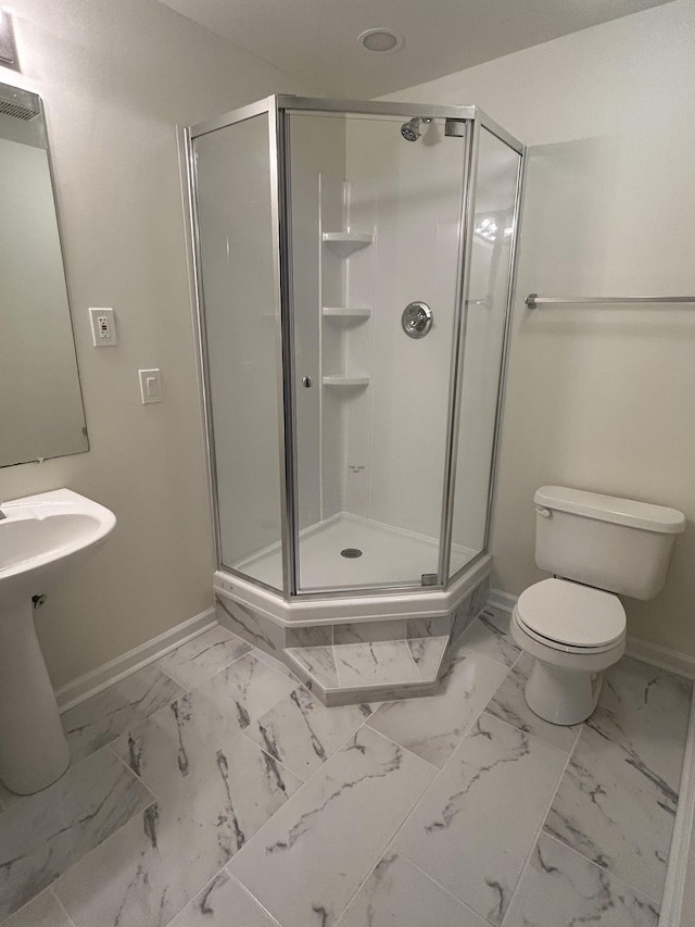 bathroom featuring baseboards and a stall shower