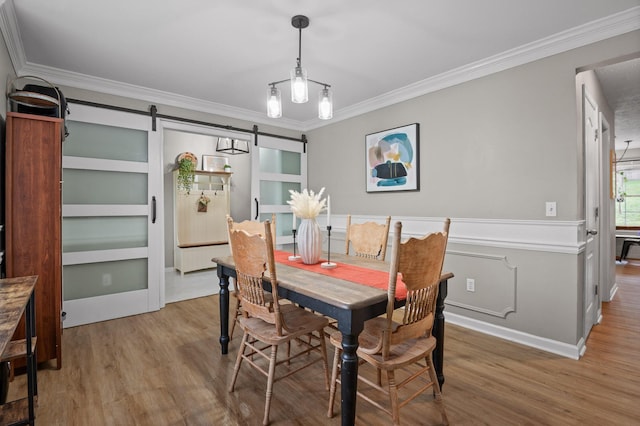 2321 Chimney Hills Dr, Soddy Daisy, TN 37379 - dining room featuring wood finished floors, ornamental molding, a barn door, and wainscoting
