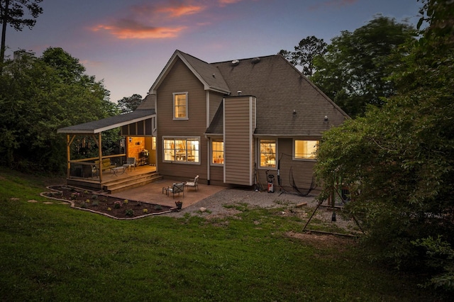 2321 Chimney Hills Dr, Soddy Daisy, TN 37379 - back of property at dusk with a deck, a patio, and a yard