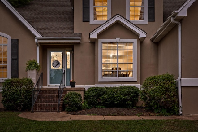 2321 Chimney Hills Dr, Soddy Daisy, TN 37379 - view of exterior entry featuring stucco siding and roof with shingles