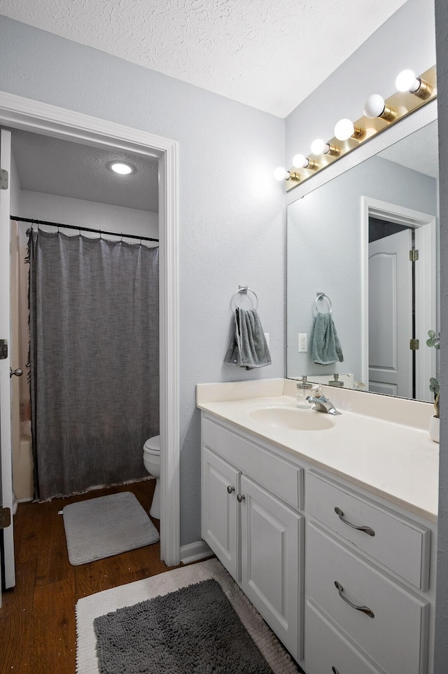 2321 Chimney Hills Dr, Soddy Daisy, TN 37379 - bathroom with vanity, toilet, wood finished floors, a textured ceiling, and shower / tub combo with curtain