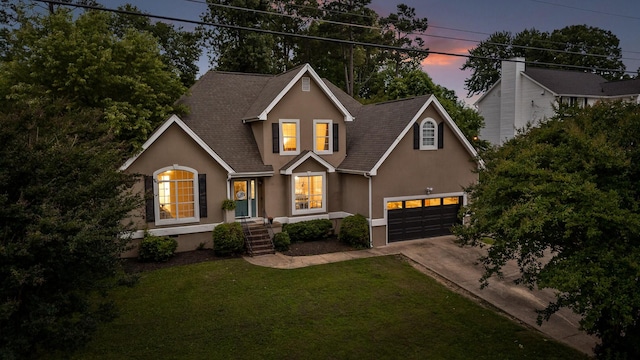 2321 Chimney Hills Dr, Soddy Daisy, TN 37379 - traditional home featuring stucco siding, driveway, a yard, a shingled roof, and an attached garage