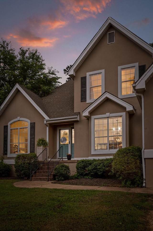2321 Chimney Hills Dr, Soddy Daisy, TN 37379 - traditional-style home featuring stucco siding, a lawn, and a shingled roof