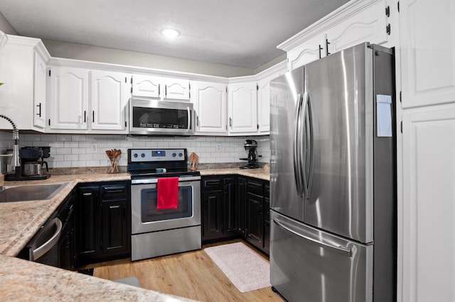 2321 Chimney Hills Dr, Soddy Daisy, TN 37379 - kitchen with appliances with stainless steel finishes, a sink, white cabinets, recessed lighting, and a textured ceiling