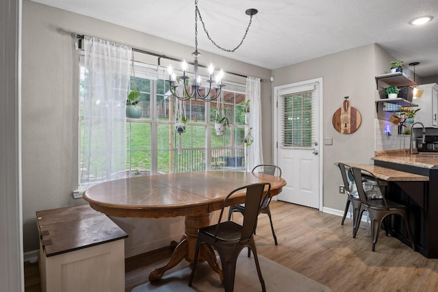 2321 Chimney Hills Dr, Soddy Daisy, TN 37379 - dining area with a chandelier, light wood finished floors, and baseboards