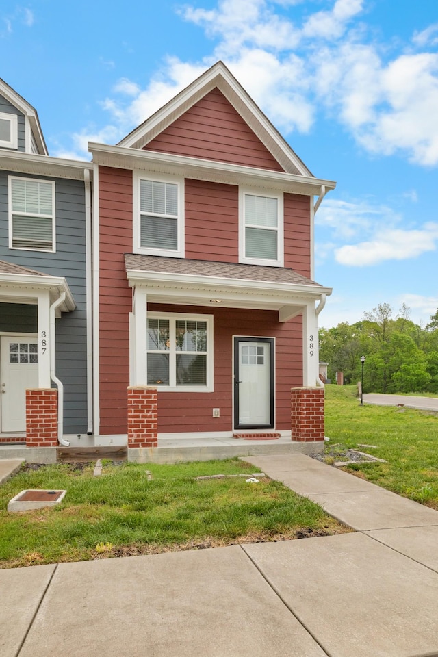 view of front of home with a front yard and covered porch