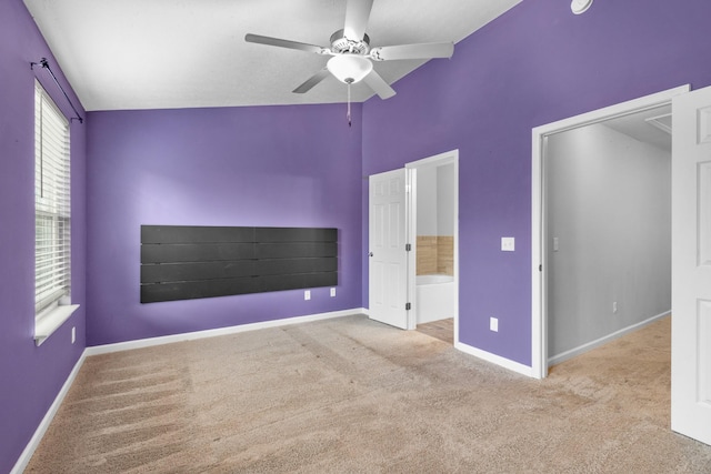 unfurnished bedroom with baseboards, ensuite bathroom, a ceiling fan, and carpet