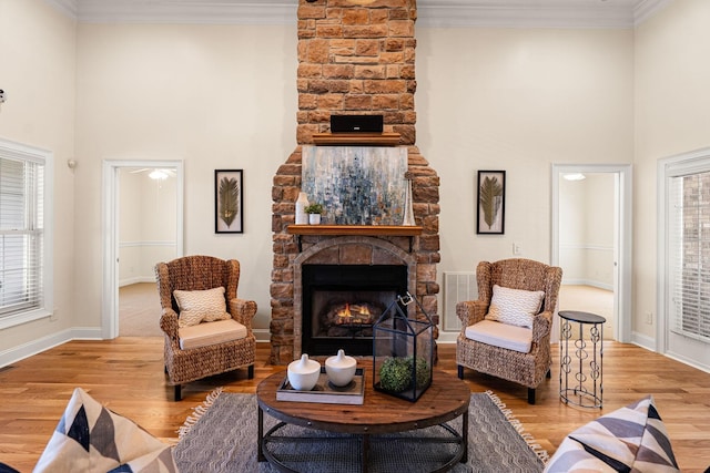 203 Tom Robinson Rd, Franklin, TN 37064 - living room with visible vents, baseboards, a high ceiling, a fireplace, and wood finished floors