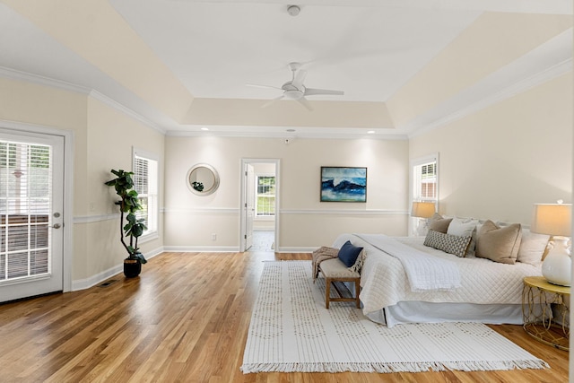 203 Tom Robinson Rd, Franklin, TN 37064 - bedroom with baseboards, light wood-style floors, a tray ceiling, and ornamental molding