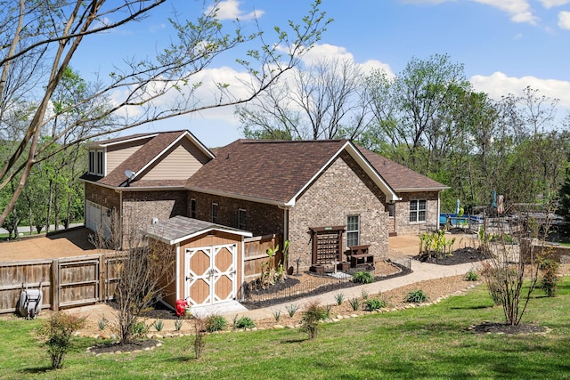 203 Tom Robinson Rd, Franklin, TN 37064 - exterior space featuring a storage shed, an outbuilding, fence, and a yard