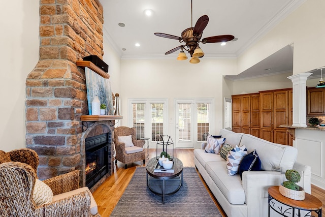203 Tom Robinson Rd, Franklin, TN 37064 - living area featuring light wood-style flooring, a large fireplace, a ceiling fan, ornamental molding, and recessed lighting