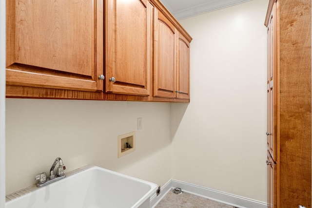 203 Tom Robinson Rd, Franklin, TN 37064 - washroom featuring baseboards, washer hookup, a sink, crown molding, and cabinet space