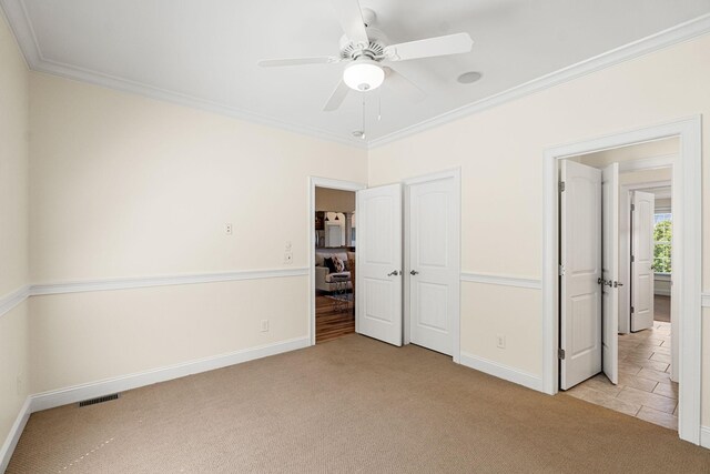 203 Tom Robinson Rd, Franklin, TN 37064 - unfurnished bedroom with crown molding, visible vents, baseboards, and light carpet