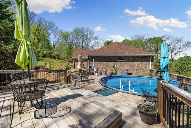 203 Tom Robinson Rd, Franklin, TN 37064 - pool featuring a wooden deck, outdoor dining area, and central AC