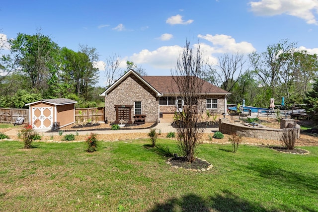 203 Tom Robinson Rd, Franklin, TN 37064 - back of house with an outdoor structure, brick siding, a storage shed, a yard, and fence