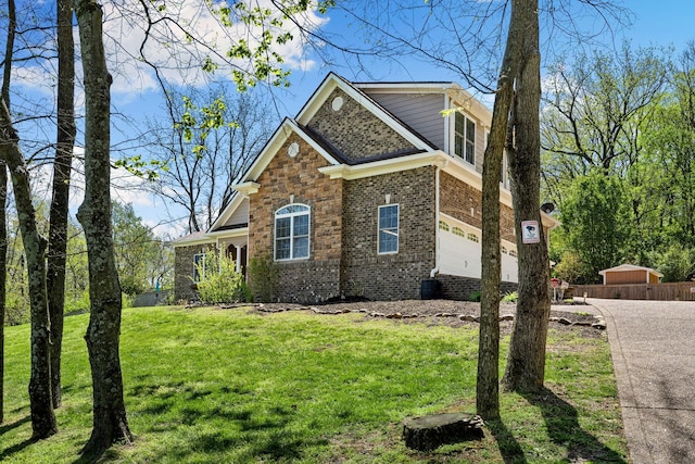 203 Tom Robinson Rd, Franklin, TN 37064 - view of front of property featuring concrete driveway, a front yard, a garage, and brick siding